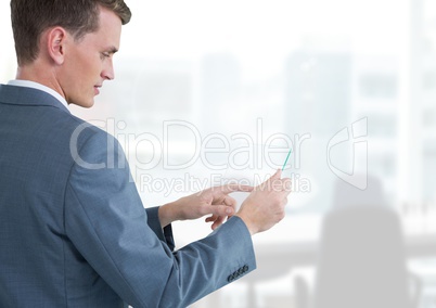 Businessman holding glass tablet in bright office