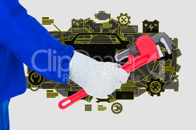 Engineer is holding a work tool against mechanic background
