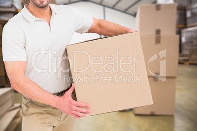 Delivery man with box in warehouse