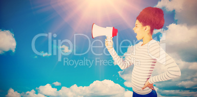 Composite image of carefree young woman shouting with megaphone