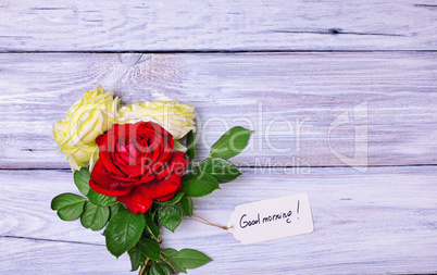 bouquet of blossoming roses with a paper tag
