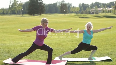 Senior fit women practicing yoga in the park