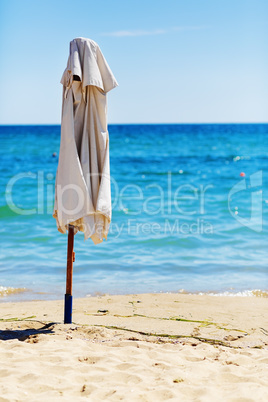 Folded beach umbrella