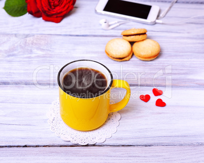 Hot black coffee in a yellow mug