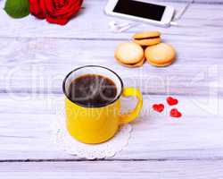 Hot black coffee in a yellow mug