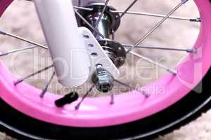 Wheel of a pink bicycle