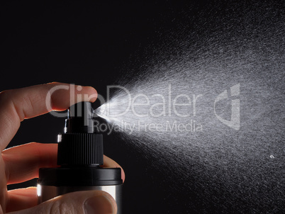 Hand with spray bottle