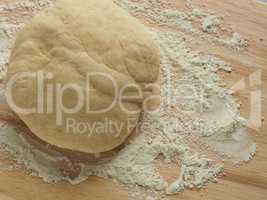 Pizza dough on wooden board