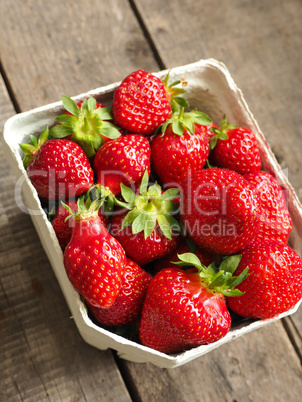 Fresh organic strawberries on wood