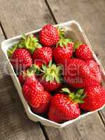 Fresh organic strawberries on wood