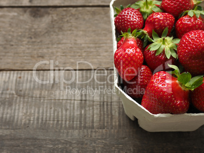 Fresh strawberries on rustic wood