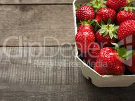 Fresh strawberries on rustic wood