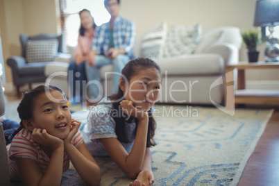 Family watching television together in living room