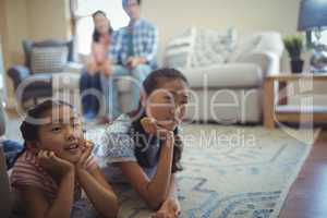 Family watching television together in living room