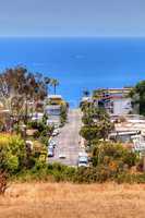 High hillside view of a Laguna Beach street that leads down to t