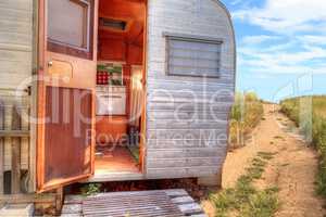 Small retro caravan camper used as a tiny house on road trips