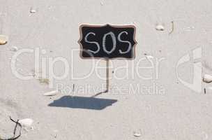 black wooden plaque with an inscription the SOS