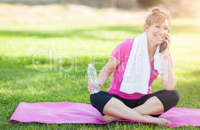Young Fit Adult Woman Outdoors with Towel and Water Bottle on Yo