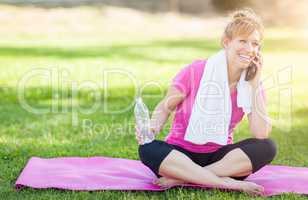 Young Fit Adult Woman Outdoors with Towel and Water Bottle on Yo