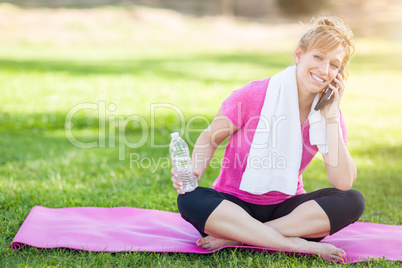 Young Fit Adult Woman Outdoors with Towel and Water Bottle on Yo