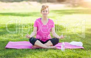 Young Fit Adult Woman Outdoors on The Grass Doing the Yoga Lotus
