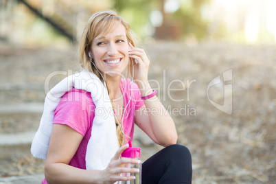 Young Fit Adult Woman Outdoors With Towel and Water Bottle in Wo