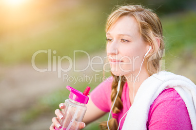 Young Fit Adult Woman Outdoors With Towel and Water Bottle in Wo