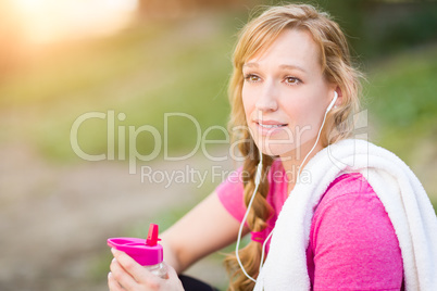 Young Fit Adult Woman Outdoors With Towel and Water Bottle in Wo