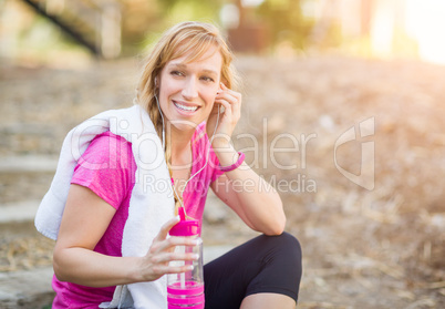 Young Fit Adult Woman Outdoors With Towel and Water Bottle in Wo