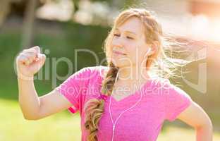 Young Fit Adult Woman Outdoors During Workout Listening To Music