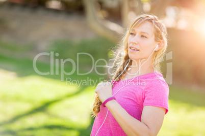 Young Fit Adult Woman Outdoors During Workout Listening To Music