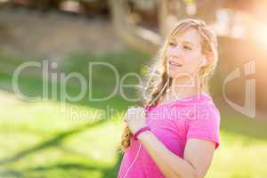 Young Fit Adult Woman Outdoors During Workout Listening To Music
