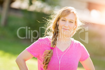Young Fit Adult Woman Outdoors Workout Clothes Listening To Musi