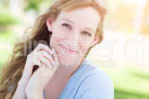 Outdoor Portrait of Young Adult Brown Eyed Woman.