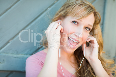 Outdoor Portrait of Young Adult Brown Eyed Woman Listening To Mu