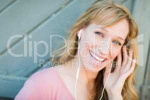 Outdoor Portrait of Young Adult Brown Eyed Woman Listening To Mu