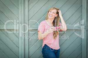 Outdoor Portrait of Young Adult Brown Eyed Woman Listening To Mu