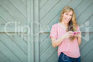 Outdoor Portrait of Young Adult Brown Eyed Woman Listening To Mu