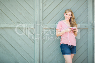 Outdoor Portrait of Young Adult Brown Eyed Woman Listening To Mu