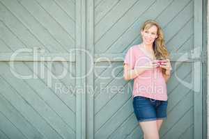 Outdoor Portrait of Young Adult Brown Eyed Woman Listening To Mu