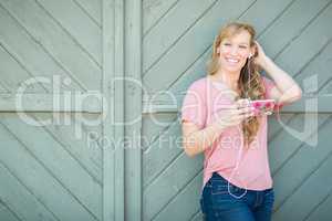 Outdoor Portrait of Young Adult Brown Eyed Woman Listening To Mu