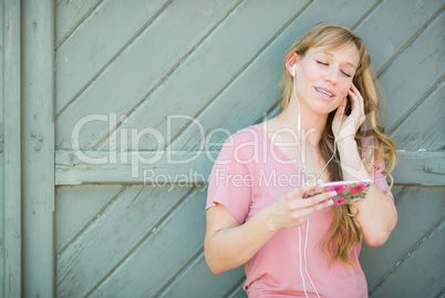 Outdoor Portrait of Young Adult Brown Eyed Woman Listening To Mu