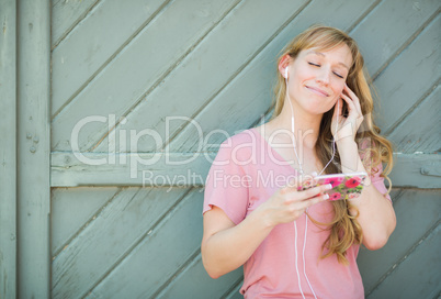 Outdoor Portrait of Young Adult Brown Eyed Woman Listening To Mu