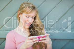 Outdoor Portrait of Young Adult Brown Eyed Woman Listening To Mu