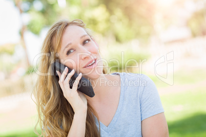 Young Adult Woman Outdoors Talking on Her Smart Phone.