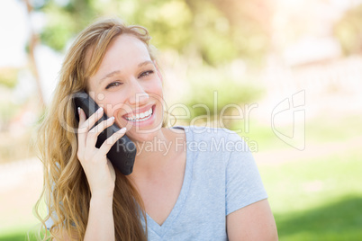 Young Adult Woman Outdoors Talking on Her Smart Phone.