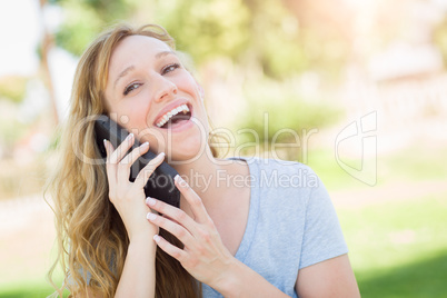 Young Adult Woman Outdoors Talking on Her Smart Phone.
