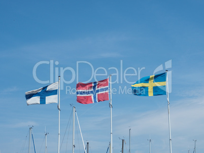 Three Scandinavian flags in a marina