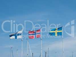 Three Scandinavian flags in a marina