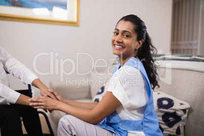 Portrait of smiling doctor touching patient hands
